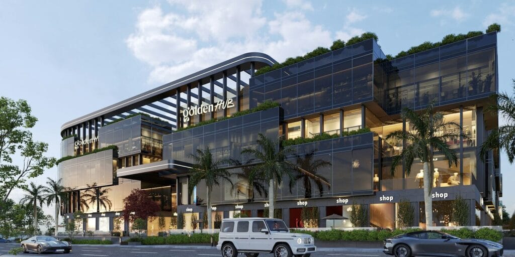 A large building with a lot of windows next to a street