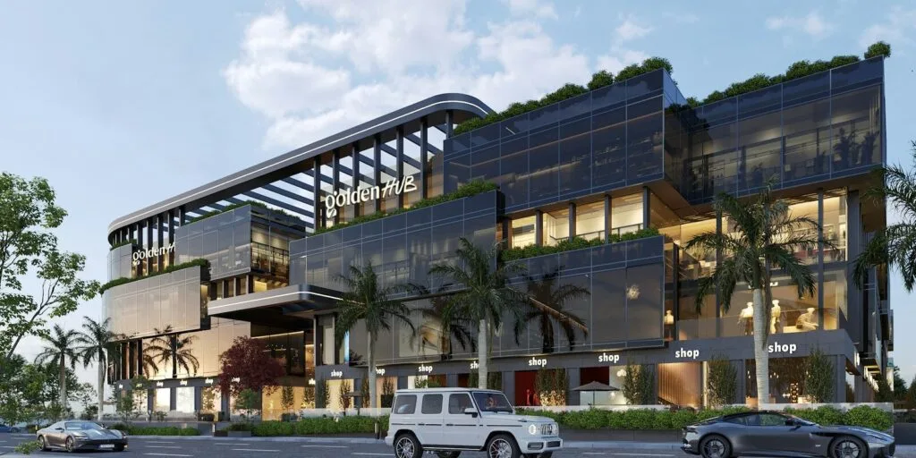 A large building with a lot of windows next to a street