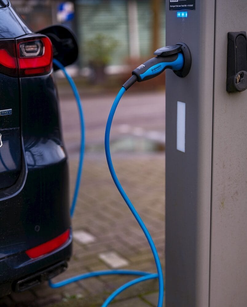 An electric car plugged in to a charging station